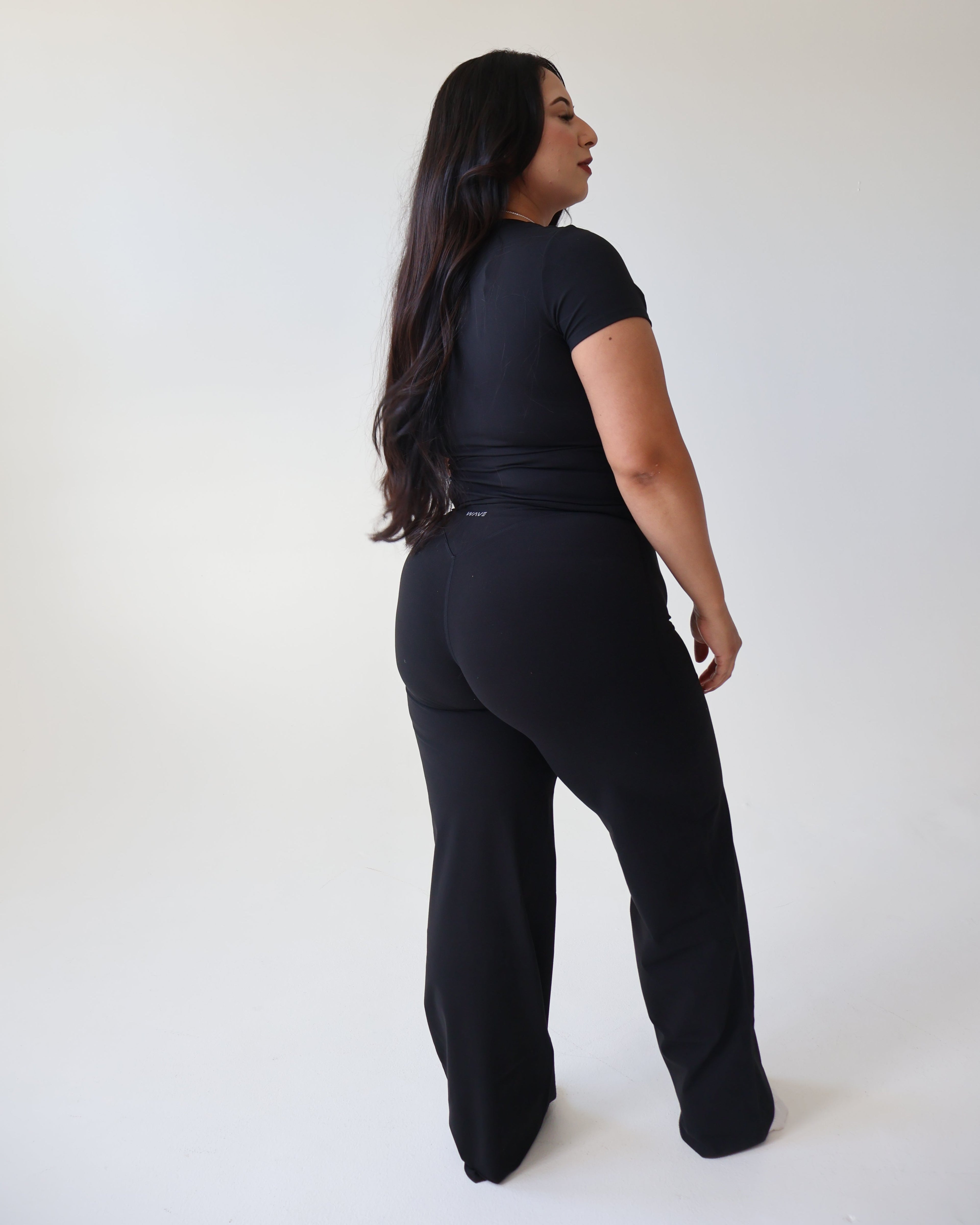 Person wearing a black outfit on a white background